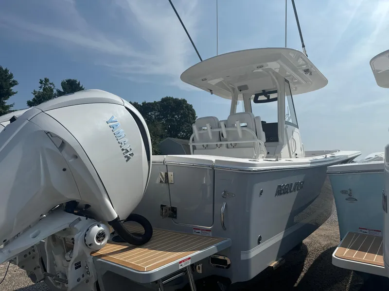 Slide: The Image of 2025 Regulator 28 boat with Yamaha engine, docked under clear sky. - 8