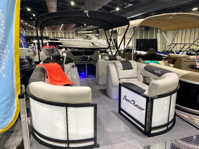 The Image of 2024 SunChaser GENEVA 22 SB pontoon boat on display at a boat show. - 1