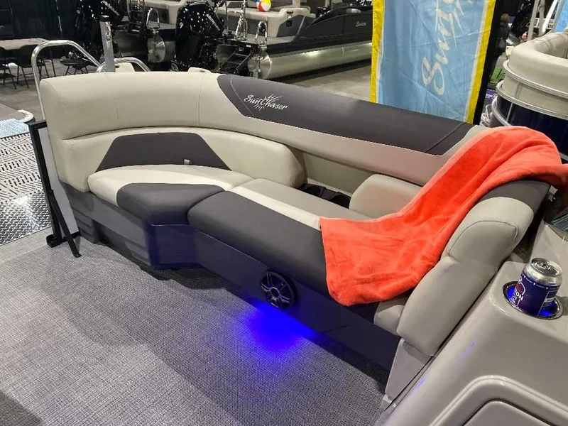 Slide: The Image of 2024 SunChaser GENEVA 22 SB boat interior with gray and black seating, red blanket, and blue LED lighting. - 13