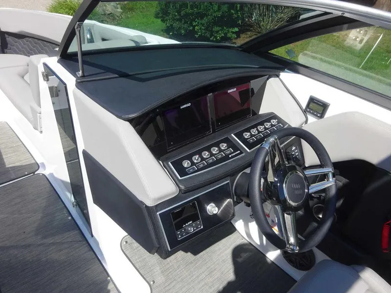 Slide: The Image of 2024 Four Winns H6 boat dashboard with modern controls and steering wheel. - 15