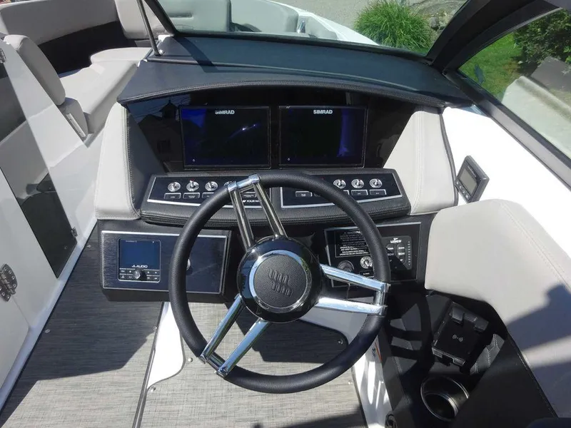 Slide: The Image of 2024 Four Winns H6 boat dashboard with modern controls and dual displays. - 16