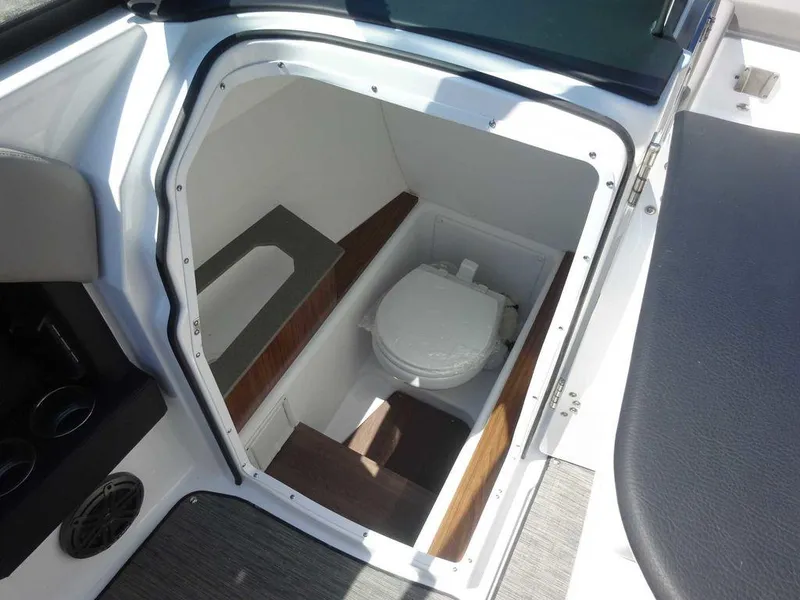 Slide: The Image of 2024 Four Winns H6 boat interior with compact marine toilet. - 21