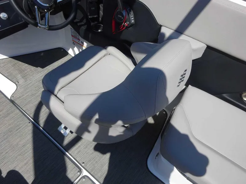 Slide: The Image of 2024 Four Winns H6 boat interior with gray seating and steering controls. - 4