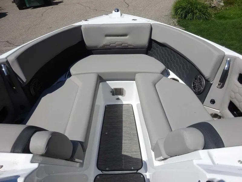 Slide: The Image of 2024 Four Winns H6 boat interior with gray cushioned seating and sleek design. - 7