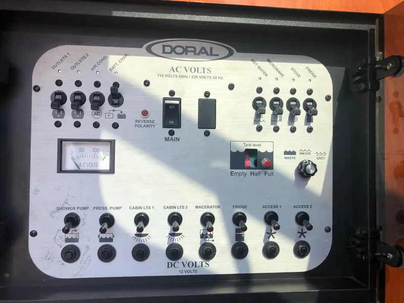 Slide: The Image of Control panel of a 2005 Doral Monticello boat, featuring AC and DC voltage switches. - 12