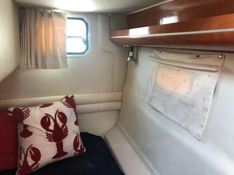 Slide: The Image of 2005 Doral Monticello cabin interior with lobster-themed pillow and wooden shelf. - 15