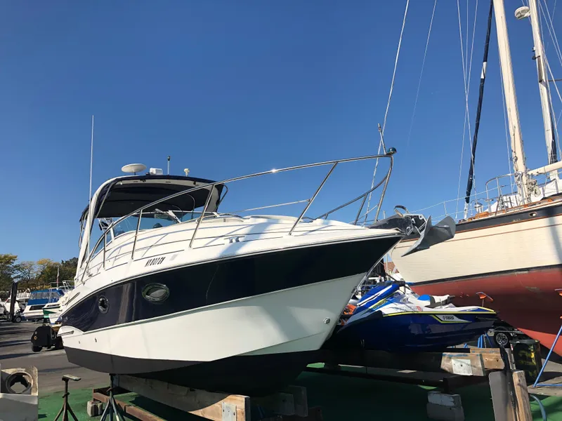 Slide: The Image of 2005 Doral Monticello boat on dry dock under clear blue sky. - 2
