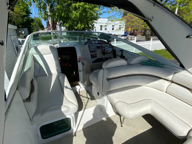 Slide: The Image of 2005 Doral Monticello boat interior with white seating and steering console. - 3