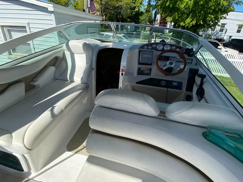 Slide: The Image of Interior of a 2005 Doral Monticello boat with white seating and control panel. - 4