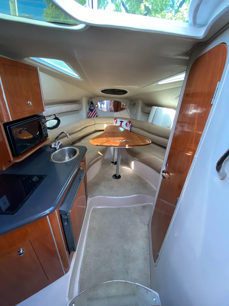 Slide: The Image of Interior of a 2005 Doral Monticello boat with kitchenette and seating area. - 5