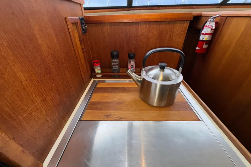 Slide: The Image of 1988 Chris-Craft 392 Commander galley with kettle, spices, and fire extinguisher. - 16