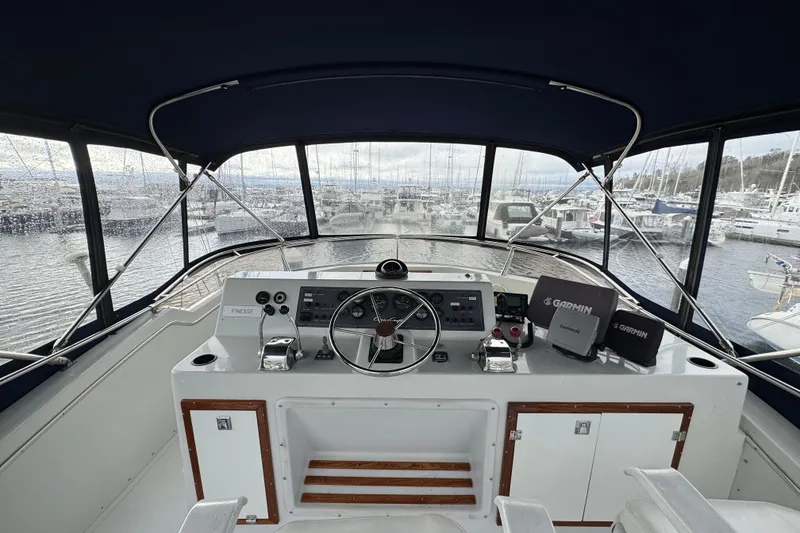 Slide: The Image of 1988 Chris-Craft 392 Commander helm with Garmin navigation, docked at marina. - 2