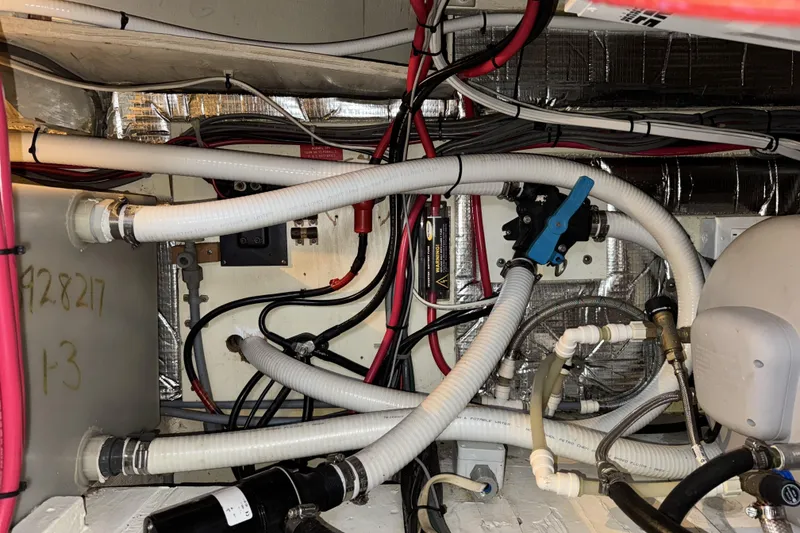 Slide: The Image of Engine room of 1988 Chris-Craft 392 Commander with hoses and wiring. - 20