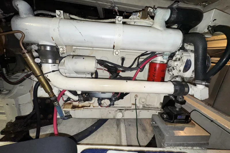 Slide: The Image of Engine compartment of 1988 Chris-Craft 392 Commander boat, showcasing mechanical components. - 21