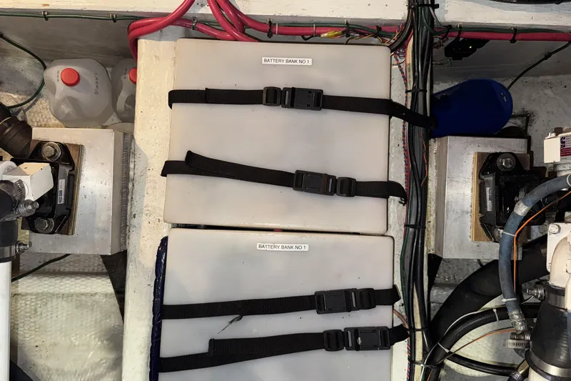 Slide: The Image of Battery compartment of 1988 Chris-Craft 392 Commander with secured battery banks and wiring. - 24