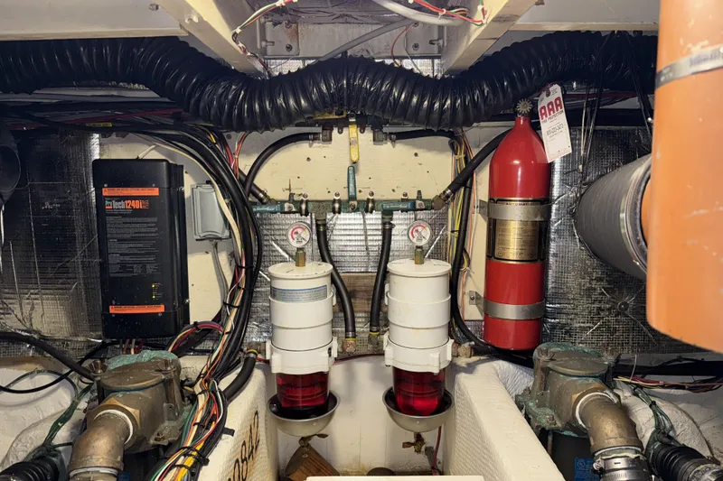 Slide: The Image of Engine room of 1988 Chris-Craft 392 Commander with fire extinguisher and fuel filters. - 25