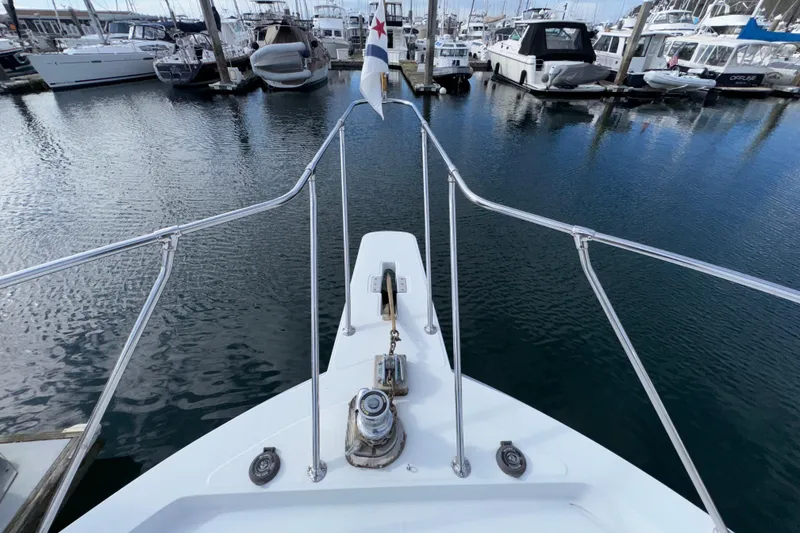 Slide: The Image of Bow view of 1988 Chris-Craft 392 Commander docked in a marina. - 27