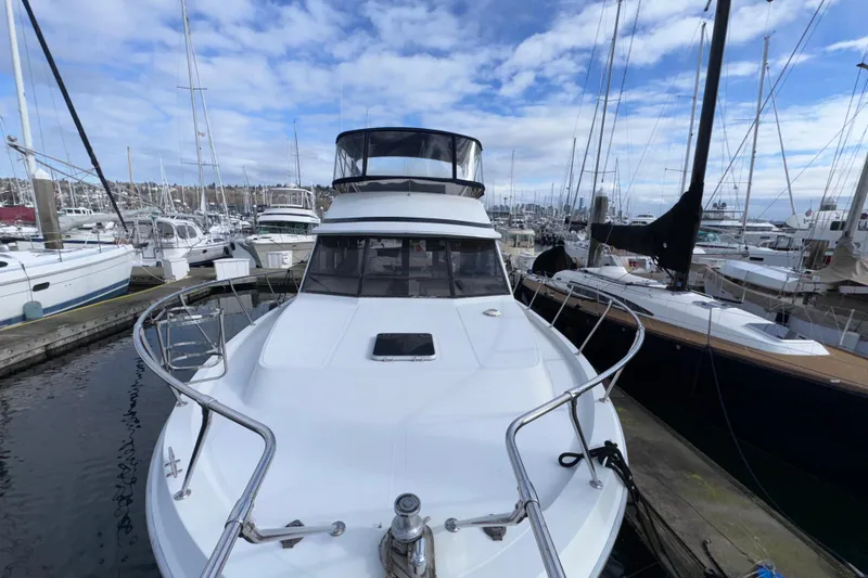 Slide: The Image of 1988 Chris-Craft 392 Commander yacht docked in a marina, surrounded by sailboats. - 28
