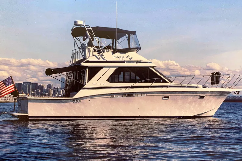 Slide: The Image of 1988 Chris-Craft 392 Commander yacht on water with city skyline. - 29