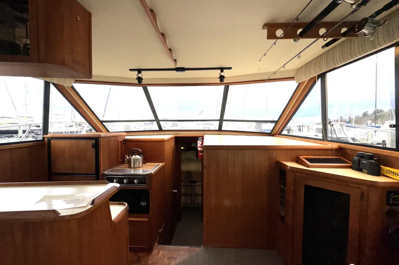 Slide: The Image of 1988 Chris-Craft 392 Commander interior with wood finish and panoramic windows. - 8
