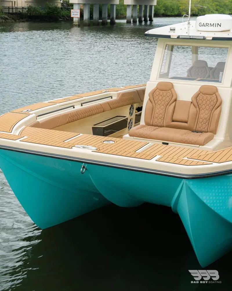 Slide: The Image of BlueCat 30 boat 2025 model with teak deck and tan seats on water. - 1