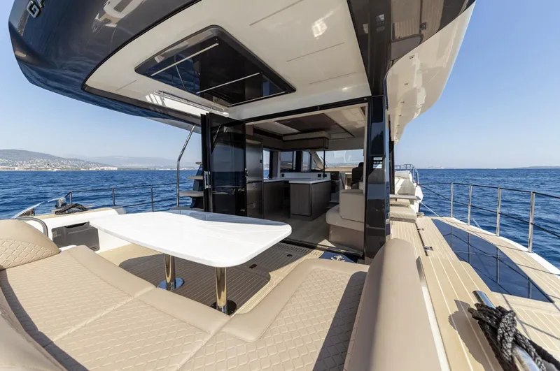 Slide: The Image of 2024 Galeon 560 Fly yacht with luxurious outdoor seating and ocean view. - 12