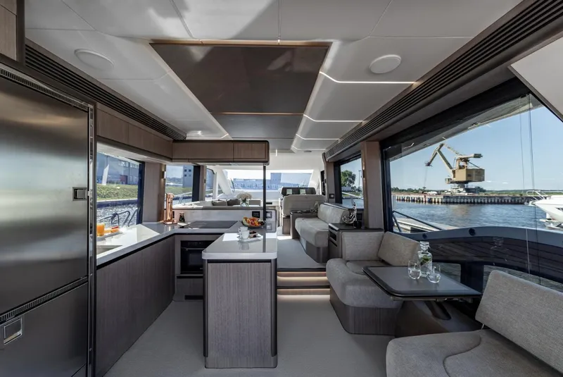 Slide: The Image of Luxurious interior of the 2024 Galeon 560 Fly yacht with modern kitchen and seating area. - 13