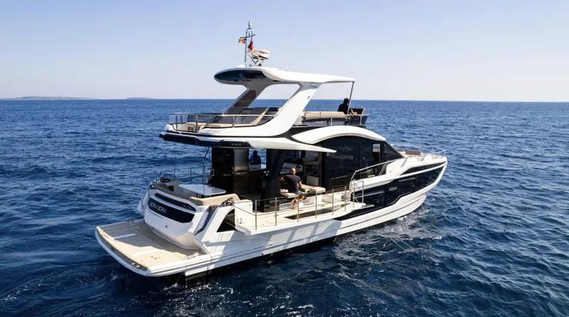 Slide: The Image of 2024 Galeon 560 Fly luxury yacht cruising on open water. - 2