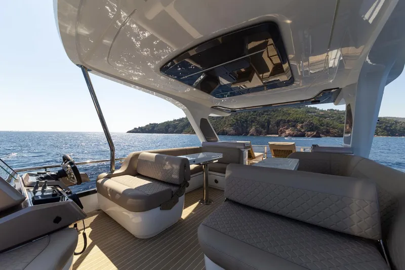 Slide: The Image of 2024 Galeon 560 Fly yacht interior with ocean view and luxurious seating. - 7
