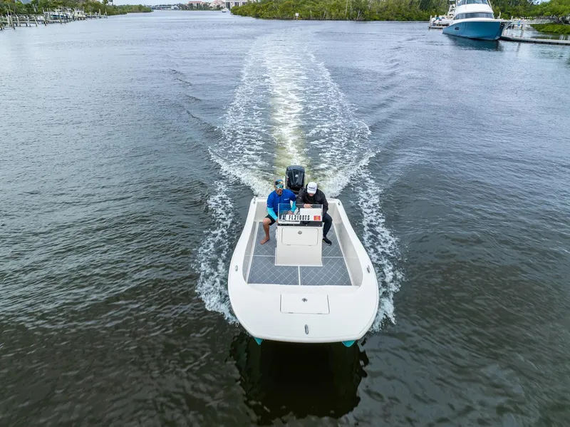 Slide: The Image of 2024 BlueCat 17 boat cruising on a river with two people onboard. - 3