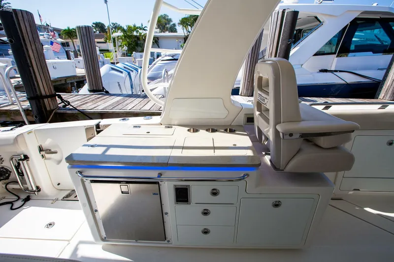 Slide: The Image of 2019 Boston Whaler 380 Realm boat interior with seating and storage compartments. - 11