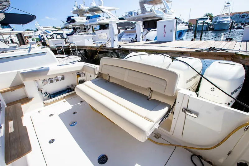 Slide: The Image of 2019 Boston Whaler 380 Realm boat with foldable seating at the dock. - 12