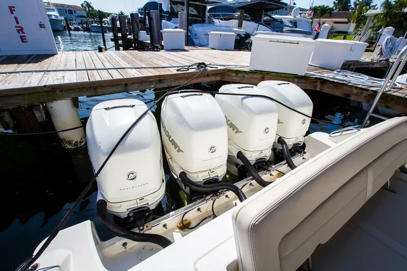 Slide: The Image of 2019 Boston Whaler 380 Realm with four Mercury outboard engines docked at marina. - 13