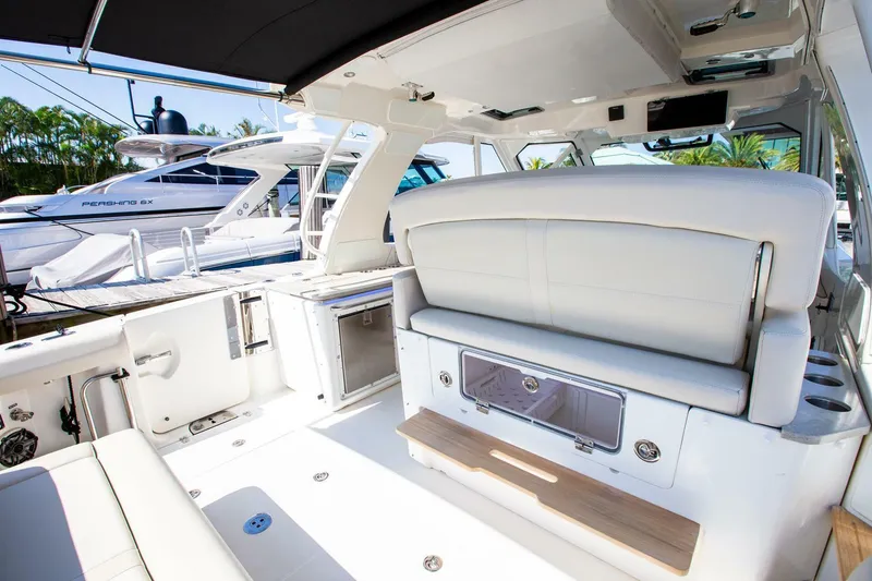 Slide: The Image of 2019 Boston Whaler 380 Realm boat interior with white seating and modern amenities. - 14