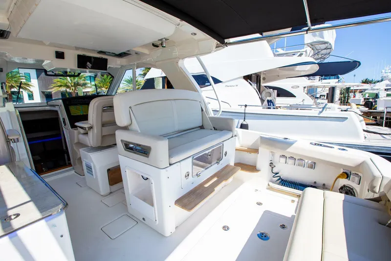 Slide: The Image of Interior of 2019 Boston Whaler 380 Realm boat with white seating and modern amenities. - 15