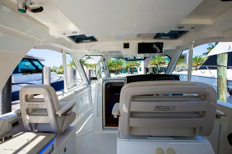 Slide: The Image of Interior of 2019 Boston Whaler 380 Realm boat with seating and helm station. - 17