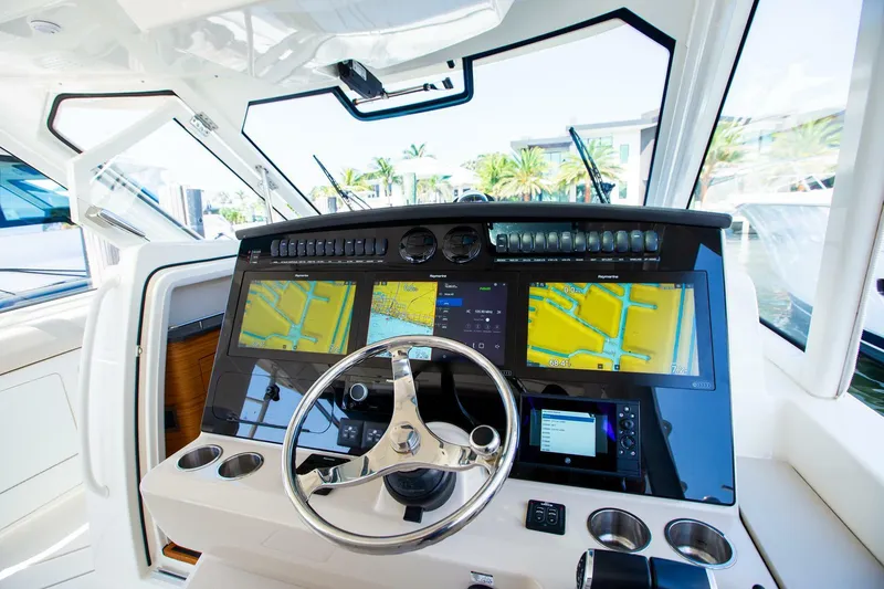 Slide: The Image of Control panel of a 2019 Boston Whaler 380 Realm boat with navigation screens. - 20