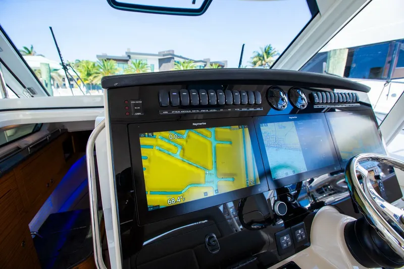 Slide: The Image of Boston Whaler 380 Realm 2019 helm with navigation screens and controls. - 23
