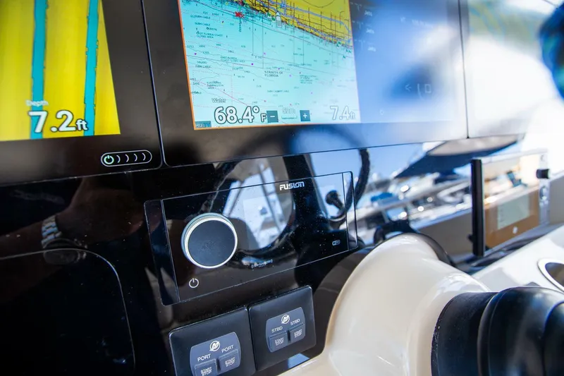 Slide: The Image of Close-up of the 2019 Boston Whaler 380 Realm's navigation and control panel. - 25