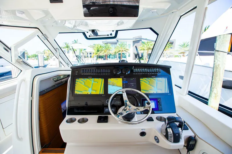 Slide: The Image of 2019 Boston Whaler 380 Realm helm with advanced navigation displays and controls. - 27