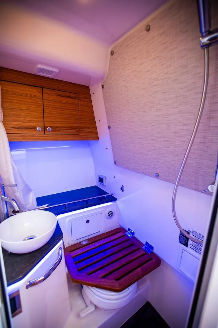 Slide: The Image of 2019 Boston Whaler 380 Realm bathroom with modern fixtures and wooden accents. - 29