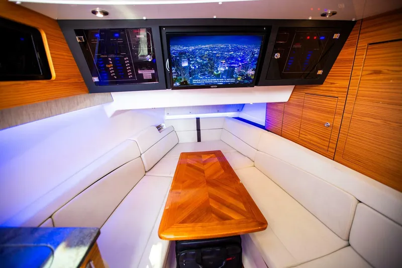 Slide: The Image of Luxurious interior of 2019 Boston Whaler 380 Realm with TV and wooden table. - 30