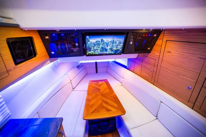 Slide: The Image of Luxurious interior of 2019 Boston Whaler 380 Realm with wood accents and a flat-screen TV. - 31