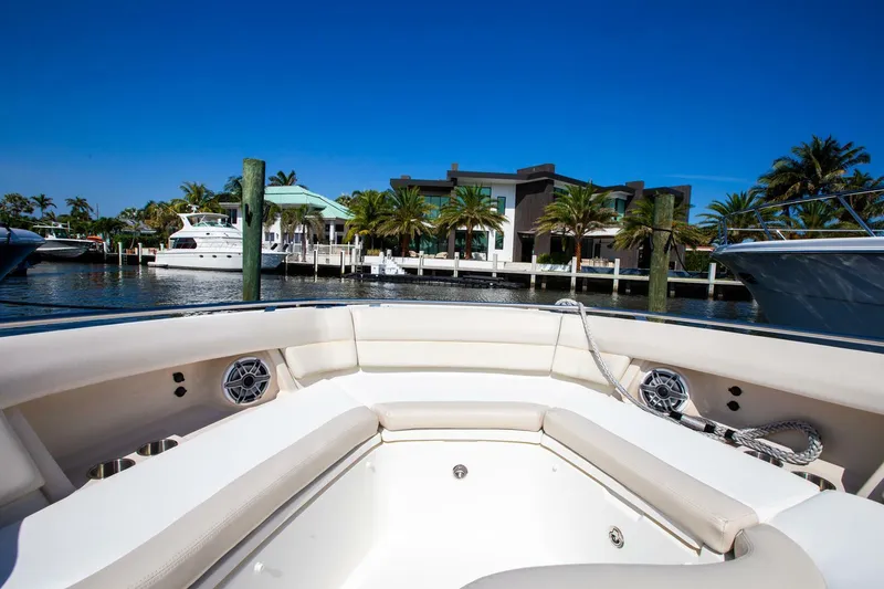Slide: The Image of 2019 Boston Whaler 380 Realm bow seating area with waterfront view. - 4