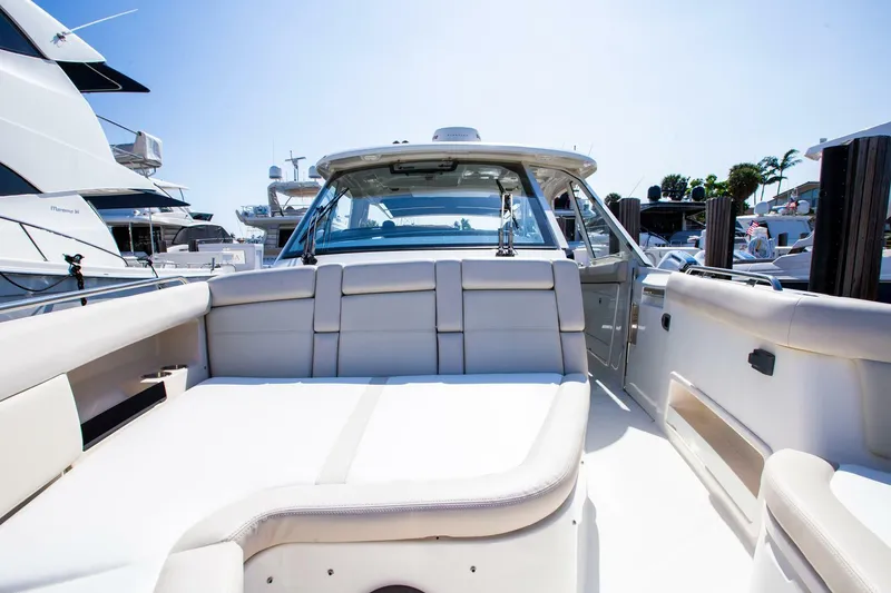 Slide: The Image of 2019 Boston Whaler 380 Realm luxury boat interior with white seating. - 6