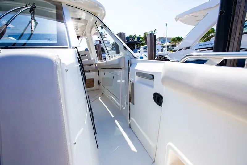 Slide: The Image of 2019 Boston Whaler 380 Realm boat interior with white seating and sleek design. - 7