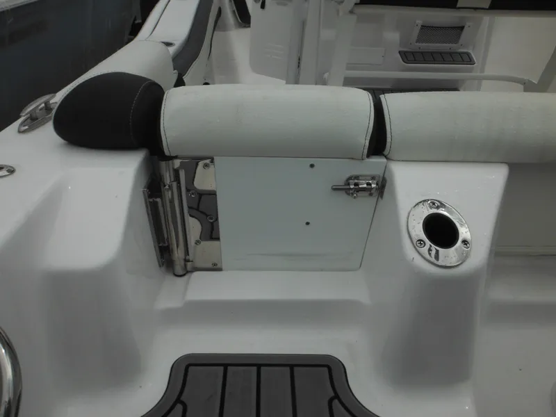 Slide: The Image of 2024 Tidewater 210 LXF boat interior with seating and storage compartment. - 14