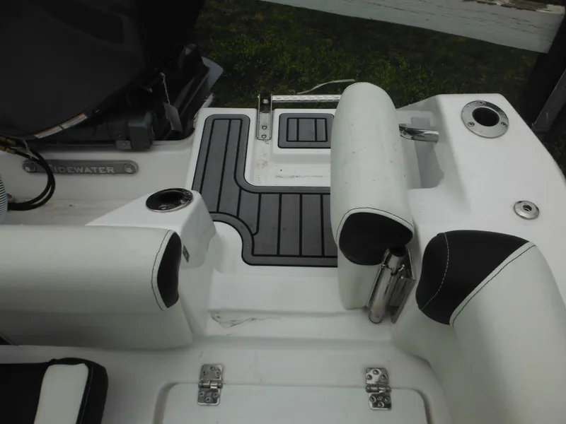 Slide: The Image of 2024 Tidewater 210 LXF boat interior with seating and storage compartments. - 17