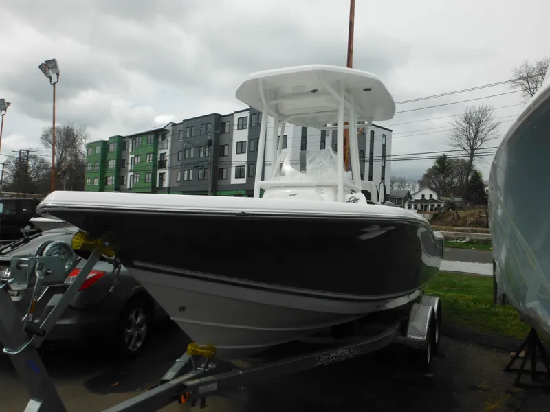 Slide: The Image of 2024 Tidewater 210 LXF boat on a trailer in a parking lot. - 2