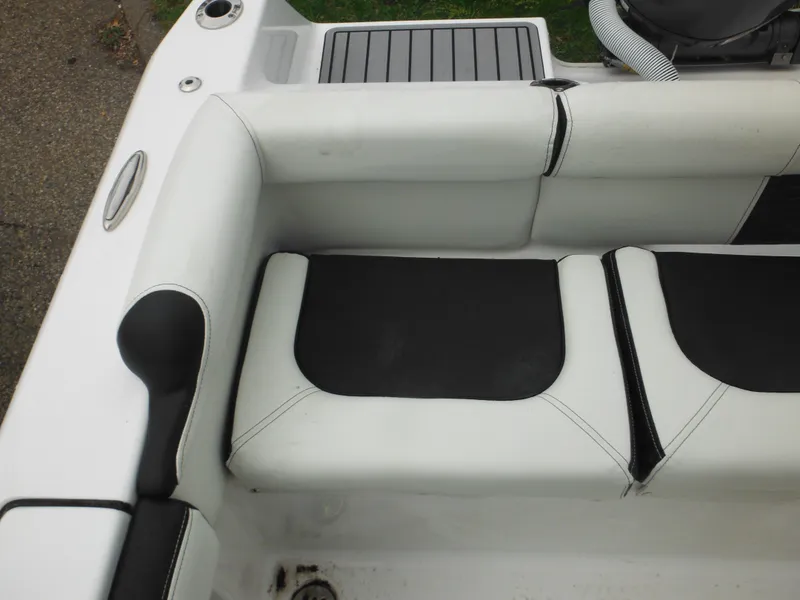 Slide: The Image of 2024 Tidewater 210 LXF boat interior seating with black and white upholstery. - 24